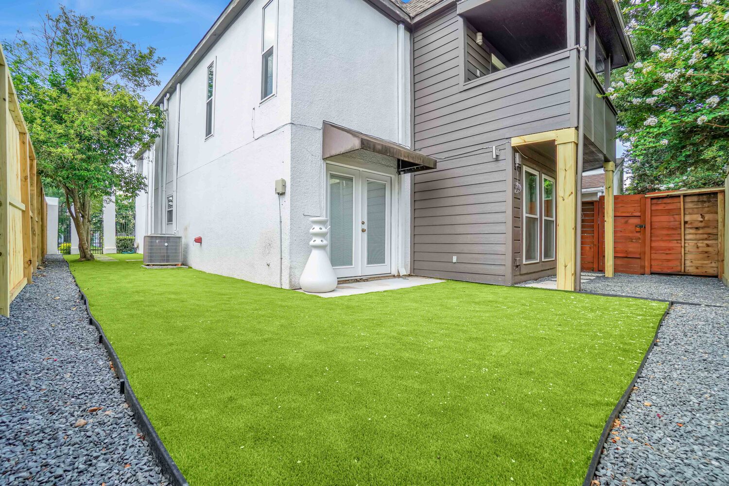 backyard with Houston artificial grass - Orion Turf and Landscape