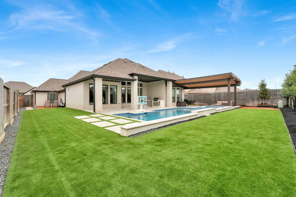 Artificial grass in the backyard by the poolside - Orion Turf and Landscape